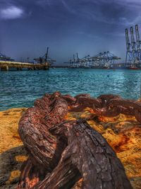 View of harbor against cloudy sky
