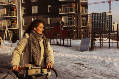 Woman with pram on playground