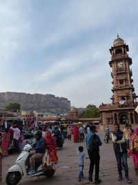 People at town square against buildings in city