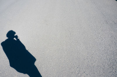 High angle view of person shadow on street