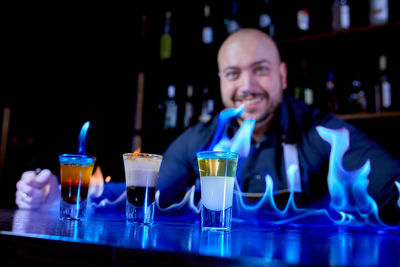 Portrait of smiling drinking glasses on table