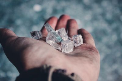 Cropped image of hand holding shattered glass