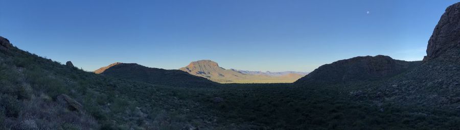 Scenic view of mountains against clear blue sky