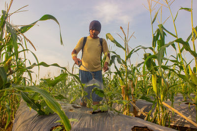 Full length of man standing on field against sky