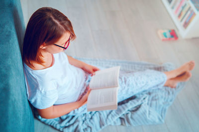 High angle view of woman sitting at home