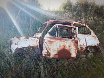 Abandoned car on field