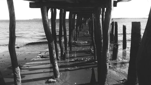 Wooden pier on sea shore against sky