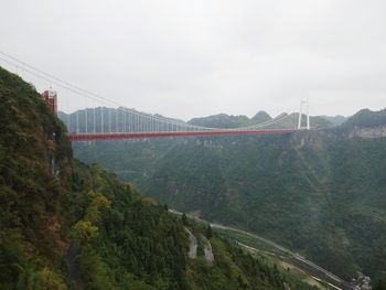 Panoramic view of suspension bridge against sky