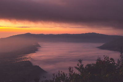 Scenic view of mountains against cloudy sky