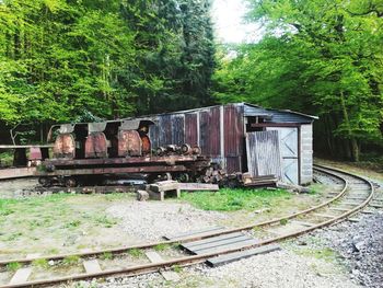 Abandoned train on railroad track in forest