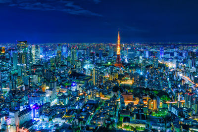 High angle view of city lit up at night