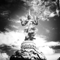 Low angle view of statue against cloudy sky