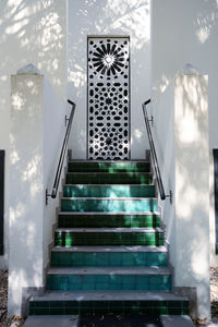 Authentic arabic style staircase. the shadow of the palm leaves on the wall. 