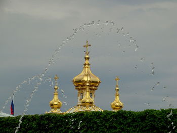 Water fountain in temple against sky