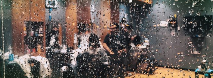 Group of people on wet window in rainy season