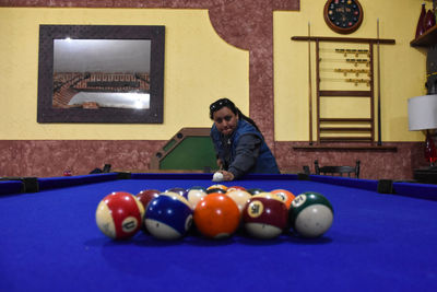 Woman playing with ball on table