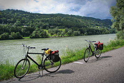 Bicycle on road by mountains against sky