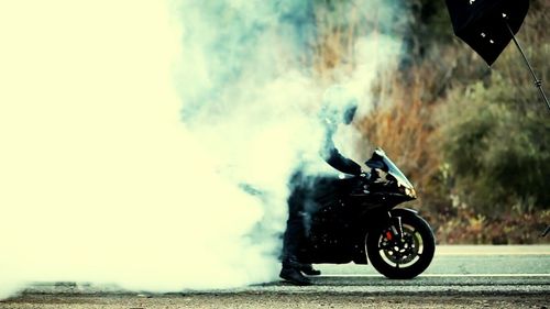 Smoke emanating from bike on road