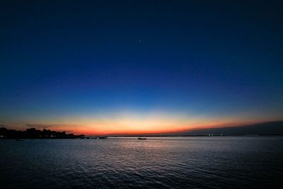 Scenic view of sea against clear sky at sunset