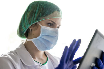 Cropped shot of an unrecognizable female nurse using a digital tablet while standing in a hospitacropped shot of an unrecognizable female nurse using a digital tablet