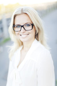 Portrait of young smiling woman wearing glasses