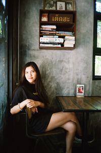 Portrait of young woman sitting on seat