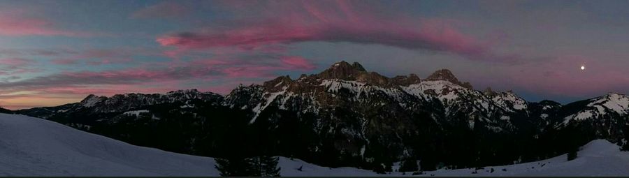 Scenic view of snow covered mountains against sky