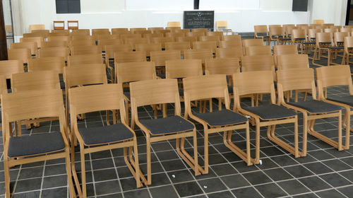 Empty chairs and table in row