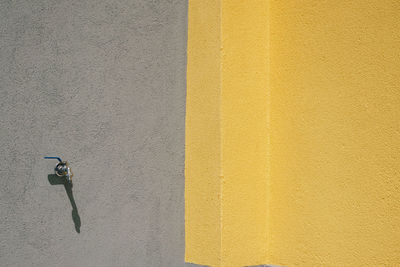 Shadow of man on yellow wall