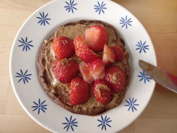 High angle view of strawberries in plate on table