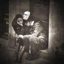 Young couple sitting in corridor