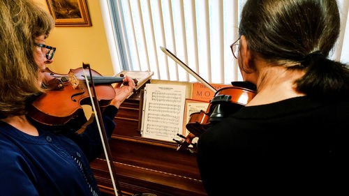 Low angle view of woman playing guitar