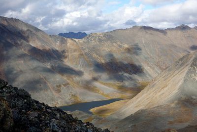 Scenic view of mountains against cloudy sky