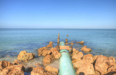 Scenic view of sea against clear blue sky