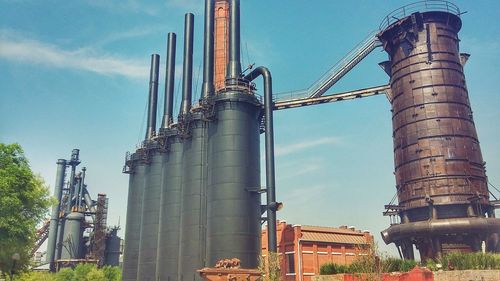 Low angle view of factory against sky