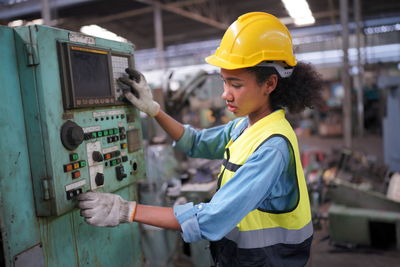 Side view of man working at construction site