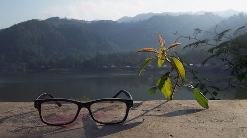 Close-up of sunglasses against sky