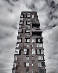 Low angle view of building against cloudy sky