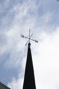 Low angle view of weather vane against sky