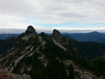 Scenic view of mountains against cloudy sky