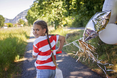 Portrait of smiling young woman holding umbrella