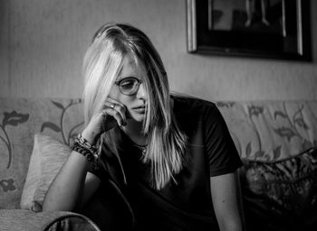 Portrait of beautiful young woman sitting at home