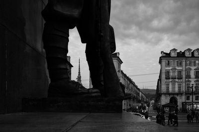 People walking in city against sky