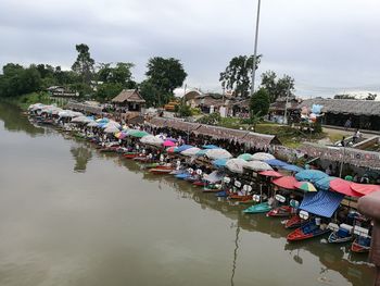 People in boat on river against sky