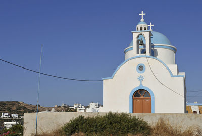 Low angle view of bell tower against blue sky