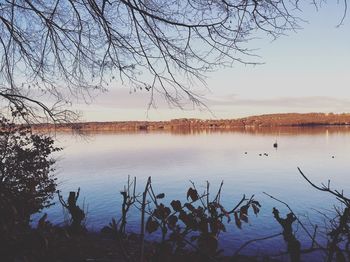 Scenic view of lake against sky at sunset