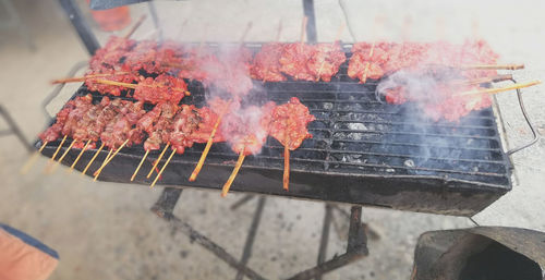 High angle view of meat on barbecue grill