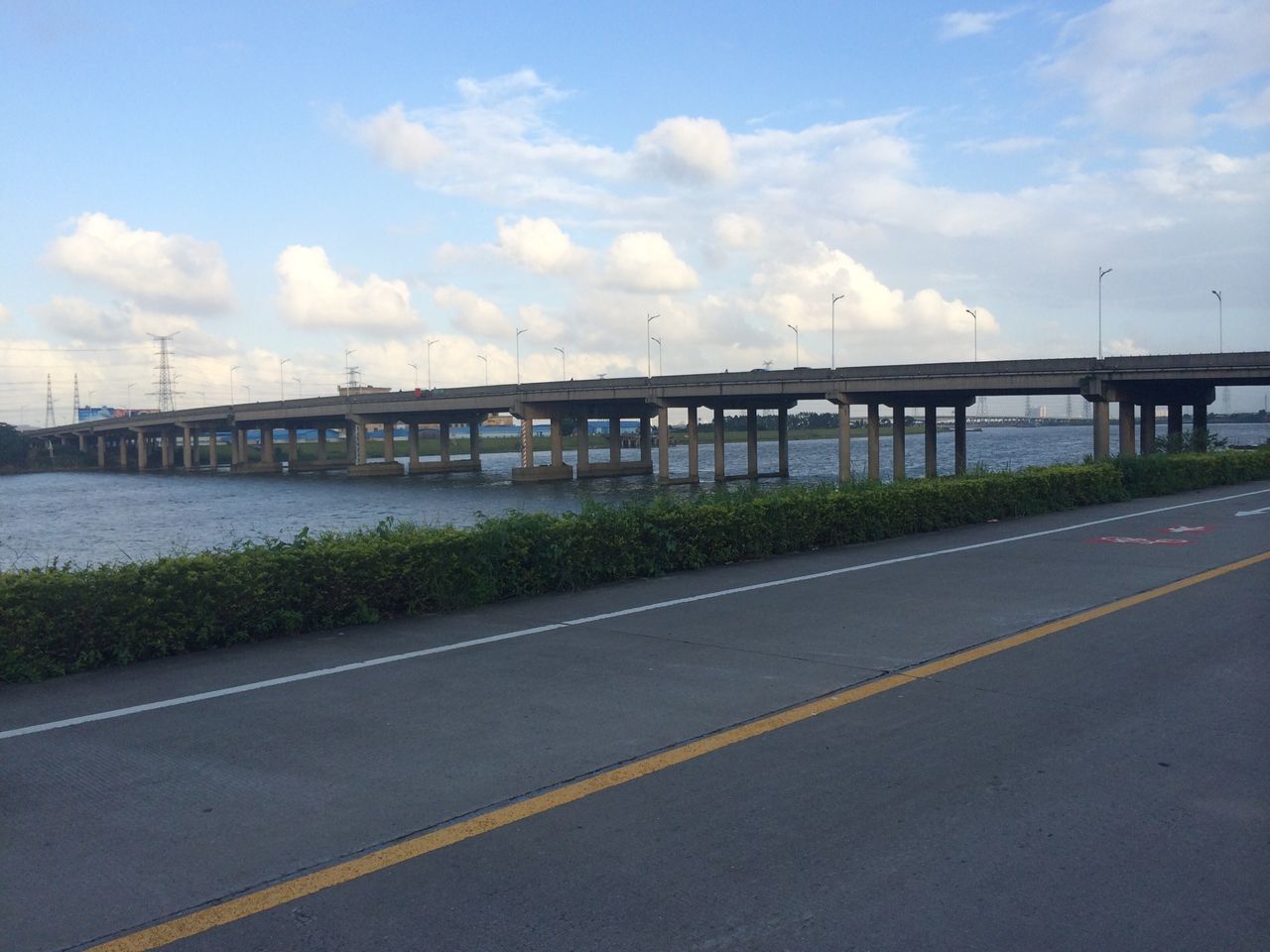 sky, road, transportation, the way forward, cloud - sky, connection, road marking, built structure, bridge - man made structure, architecture, cloud, diminishing perspective, cloudy, long, street, railing, asphalt, street light, vanishing point, outdoors