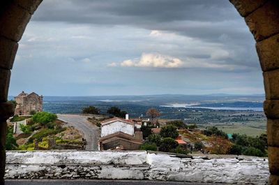 Scenic view of sea and town against sky