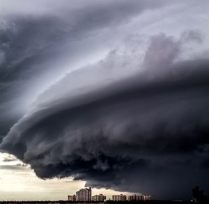 Low angle view of storm clouds over city